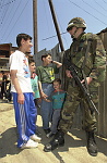 Kosovo trip
Specialist Travis Surprise a member of the 40th Combat Engineers stationed at Camp Monteith, talks to a group of ethnic Albanian boys during a foot patrol through the town of Gjilan.