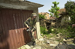 Kosovo trip
Sgt. Albert Rodriguez, a members of the 40th Combat Engineers stationed at Camp Monteith, walks around barbed wire surrounding a Serb enclave protected by US soldiers during a foot patrol through the town of Gjilan.