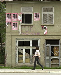 Kosovo trip
Ethnic Albanian girl passes house with political posters for the PDK (Kosovo Democratic Party) displayed.