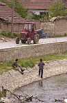 Kosovo trip
Farm tractor pass two boys fishing in a polluted river that runs through the town of Vitina.